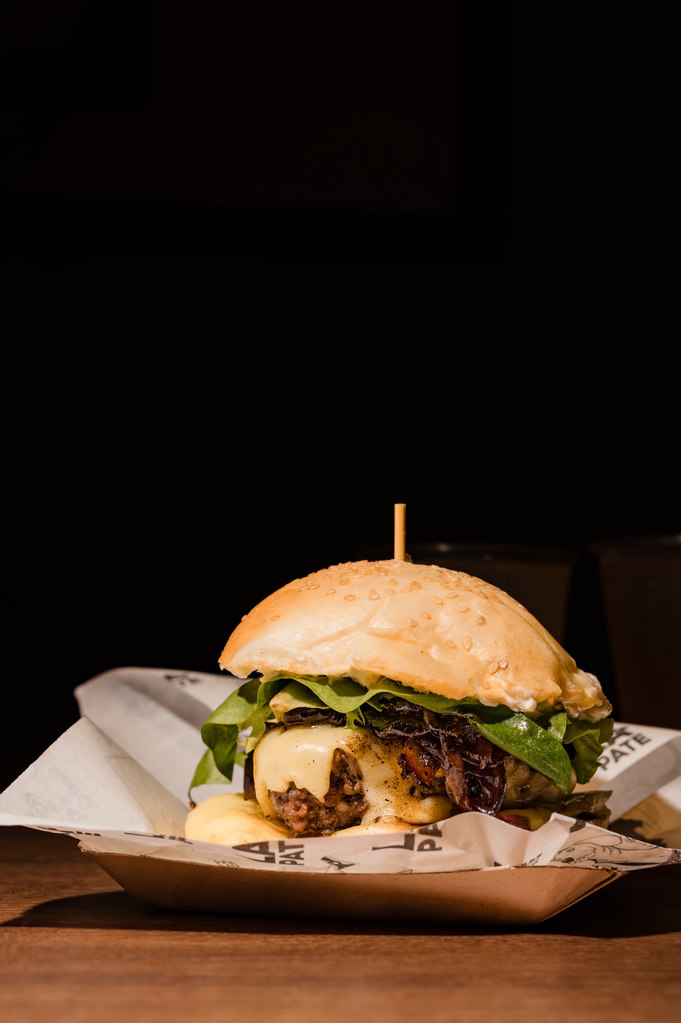 Hamburguesa de La Pate con queso, cebolla y hojas verdes